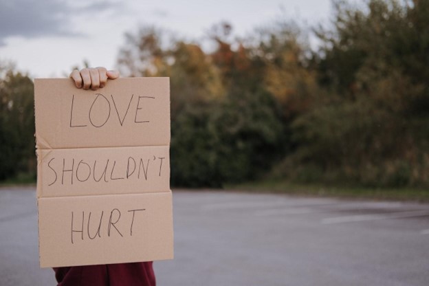 image of a sign saying Love shouldn't hurt.
